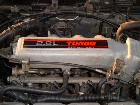 1991 Ford Probe - Close-up of an engine intake manifold showing "2.2L TURBO INTERCOOLED" labeling.