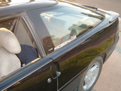 1991 Ford Probe - A sticker on the rear window of a black coupe reads PROBESNW.COM.