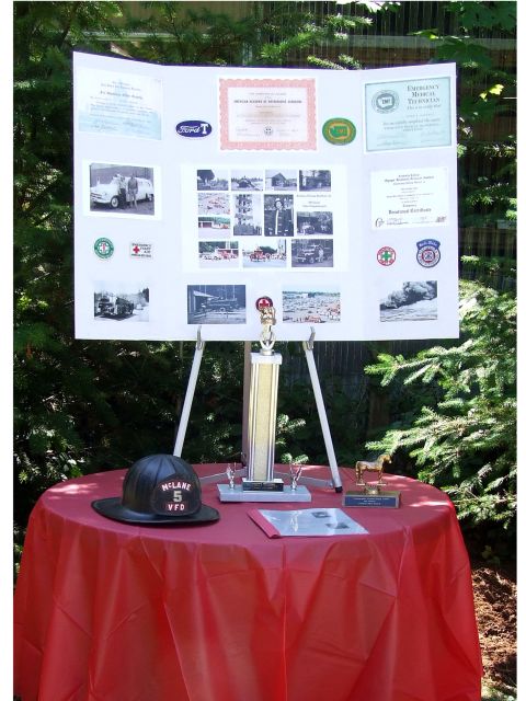 1976 Ford F-150 - A memorial display board features historical photos and documents related to emergency services and vehicles.