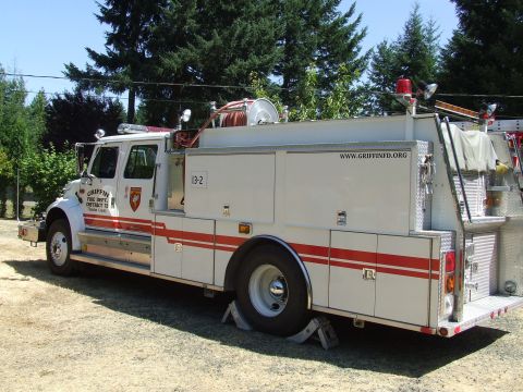 1976 Ford F-150 - A white fire truck with red stripes and "GRIFFIN FIRE DEPT. DISTRICT 13" markings is parked outdoors.