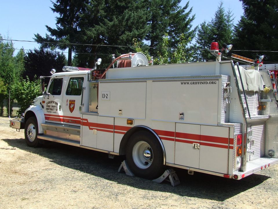 White fire truck with red stripes, labeled "GRIFFIN FIRE DEPT. DISTRICT 13"