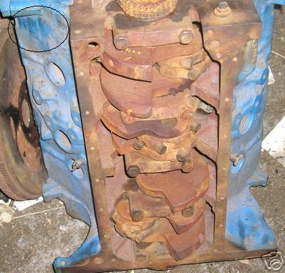 1975 Ford F-150 - Close-up view of a disassembled engine block showing the crankshaft and connecting rods.
