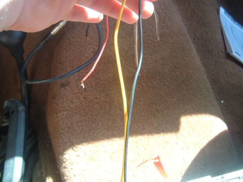1988 Ford Bronco - Wires are visible against the carpeted interior of a vehicle.