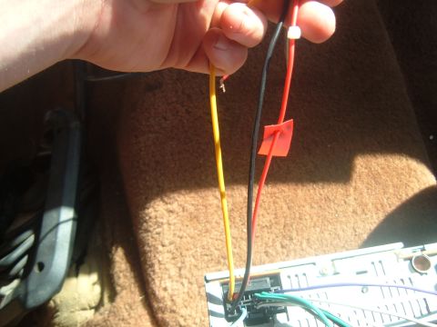 1988 Ford Bronco - Close-up of car stereo wiring, showing connections for power and speakers.