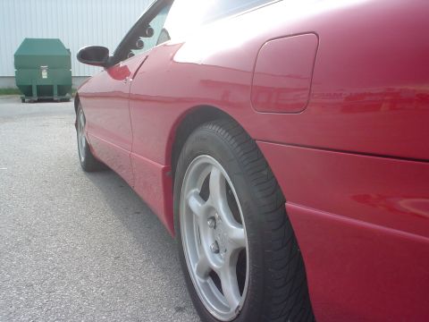 1996 Ford Probe - A red 1996 Ford Probe is shown from the side, with a dumpster in the background.
