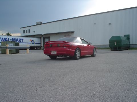 1996 Ford Probe - Red 1996 Ford Probe seen from the rear in a parking lot next to a Walmart truck.