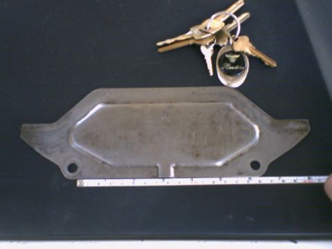 1973 Ford Ranchero - A metal dust cover plate is shown with a set of keys, one of which has a 'Ranchero' keychain.