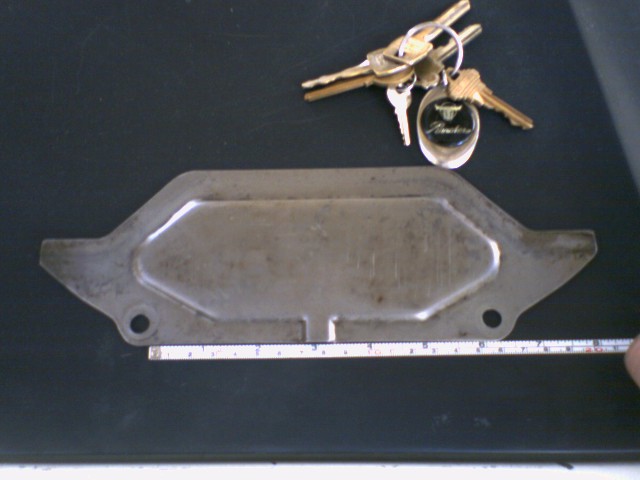 Metal dust cover plate with a keychain showing 'Ranchero' text