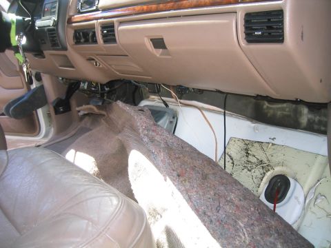 1996 Ford Bronco - peel the carpet back and pull it through, unhook it from the coathanger and pull it back out the first hole