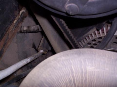 1995 Ford Bronco - This image shows a close-up view of engine components, including a belt and alternator, with some visible rust.