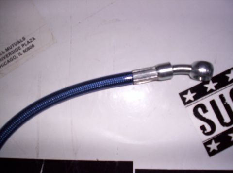 1995 Ford Bronco - A close-up of a blue braided brake hose with a silver fitting.