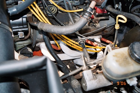 1991 Ford Bronco - Close-up view of a vehicle's engine compartment, showing various mechanical parts and wiring.