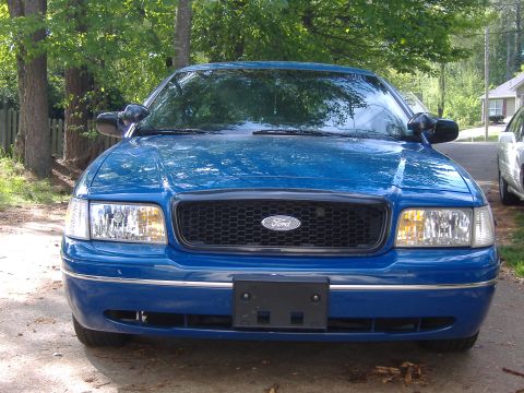1998 Ford Crown Victoria - Front view of a blue 1998 Ford Crown Victoria parked outdoors.