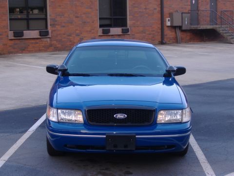 1998 Ford Crown Victoria - Front view of a blue 1998 Ford Crown Victoria parked in a lot.