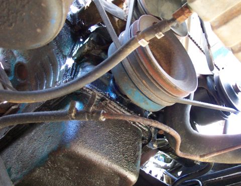 1975 Ford F-150 - Close-up view of engine components including pulleys and belts.