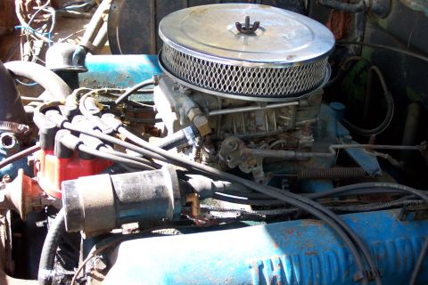 1975 Ford F-150 - Close-up view of an engine bay a carburetor and air cleaner assembly.
