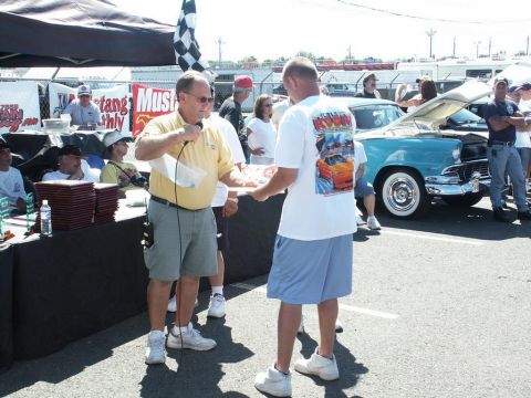 2001 Mercury Grand Marquis - Car show awards ceremony with a classic blue car visible in the background.