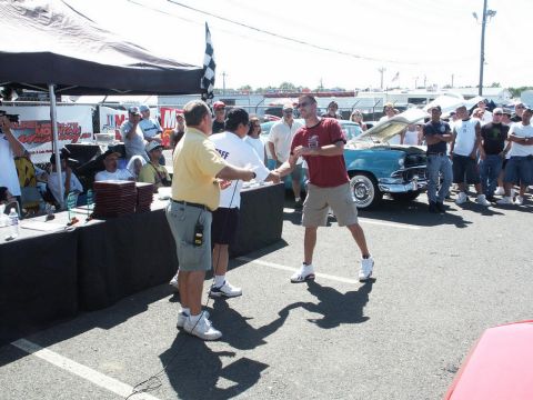 2001 Mercury Grand Marquis - Attendees gather at a car show event, with a vintage car visible behind the award ceremony.