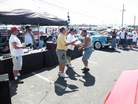 2001 Mercury Grand Marquis - A car show event with an award presentation and a crowd gathered around classic vehicles.