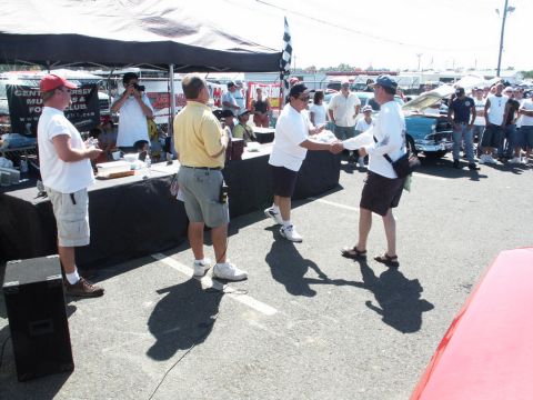2001 Mercury Grand Marquis - Attendees gather at a car show, with a checkered flag and tents visible in the background.