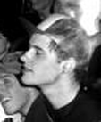 1969 Ford Mustang - A black and white photo shows a young man in profile, with another person partially visible behind him.