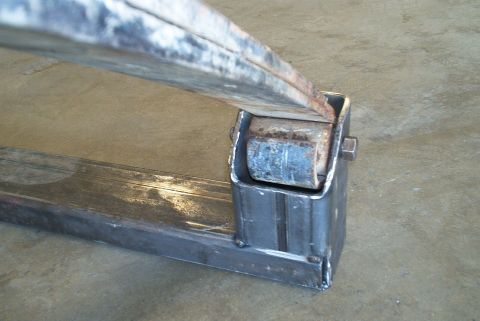 1983 Ford Bronco - Close-up of a metal crossmember part, with the Supermotors logo visible in the lower right corner.