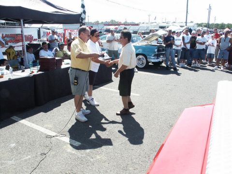 2001 Mercury Grand Marquis - Award ceremony at a car show with a crowd and vintage vehicles present.