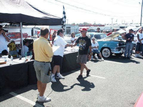 2001 Mercury Grand Marquis - An award is presented at a car show event, with attendees gathered around a classic car.