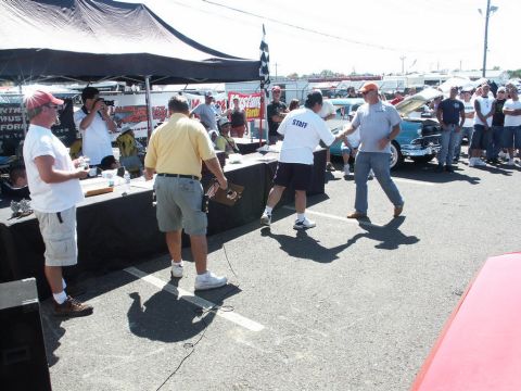 2001 Mercury Grand Marquis - A car show event with attendees and tents, a blue car visible in the background.
