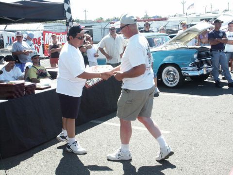 2001 Mercury Grand Marquis - A car show award is presented in front of a classic turquoise Ford Fairlane with its hood open.