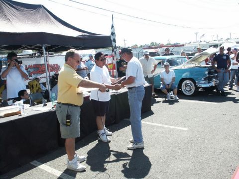 2001 Mercury Grand Marquis - Award ceremony at a car show with a turquoise 1956 Ford Fairlane Crown Victoria on display.