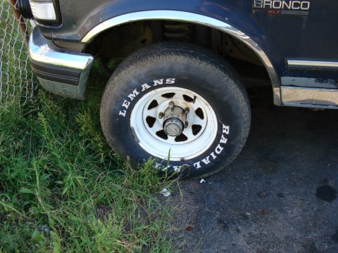 1994 Ford Bronco - Close-up of the front wheel and fender area of a 1994 Ford Bronco XLT.