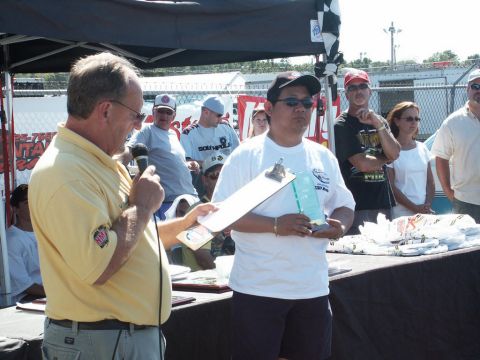 2001 Mercury Grand Marquis - An award ceremony is underway at an outdoor event, with participants gathered around.