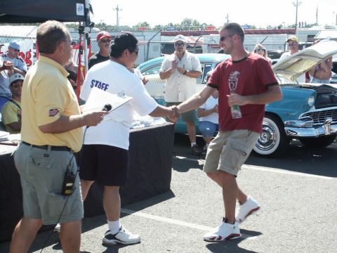 2001 Mercury Grand Marquis - Award ceremony at a car show with a classic car on display.