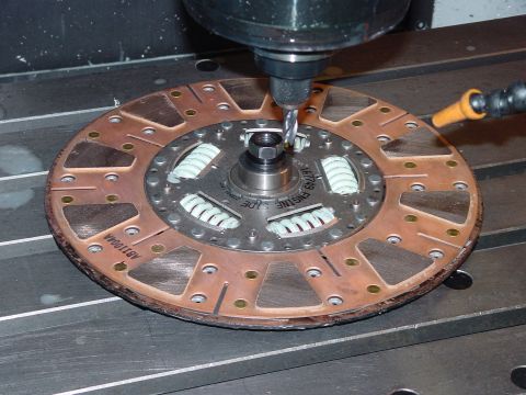 1979 Ford Bronco - A clutch disc, identified by part number 167749, is shown being machined on a milling machine.