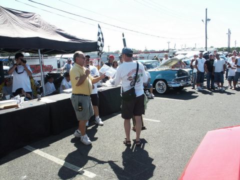 2001 Mercury Grand Marquis - A classic blue car is displayed with its hood open at a car show, drawing a crowd of onlookers.