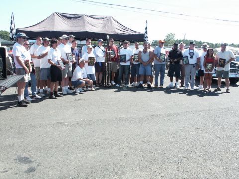2001 Mercury Grand Marquis - Attendees pose for a photo with their awards at an outdoor car show event.