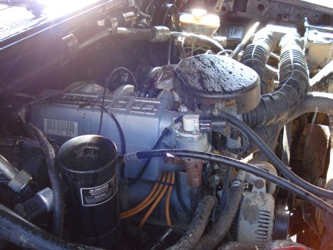 1994 Ford Bronco - Close-up view of an engine bay, showing various components and hoses.