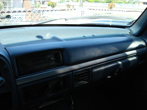 1994 Ford Bronco - The interior dashboard of a vehicle is shown, with a focus on the center console area.