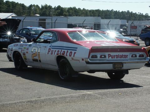 2001 Mercury Grand Marquis - A Mercury race car with number 21 and Purolator branding is parked at an outdoor event.
