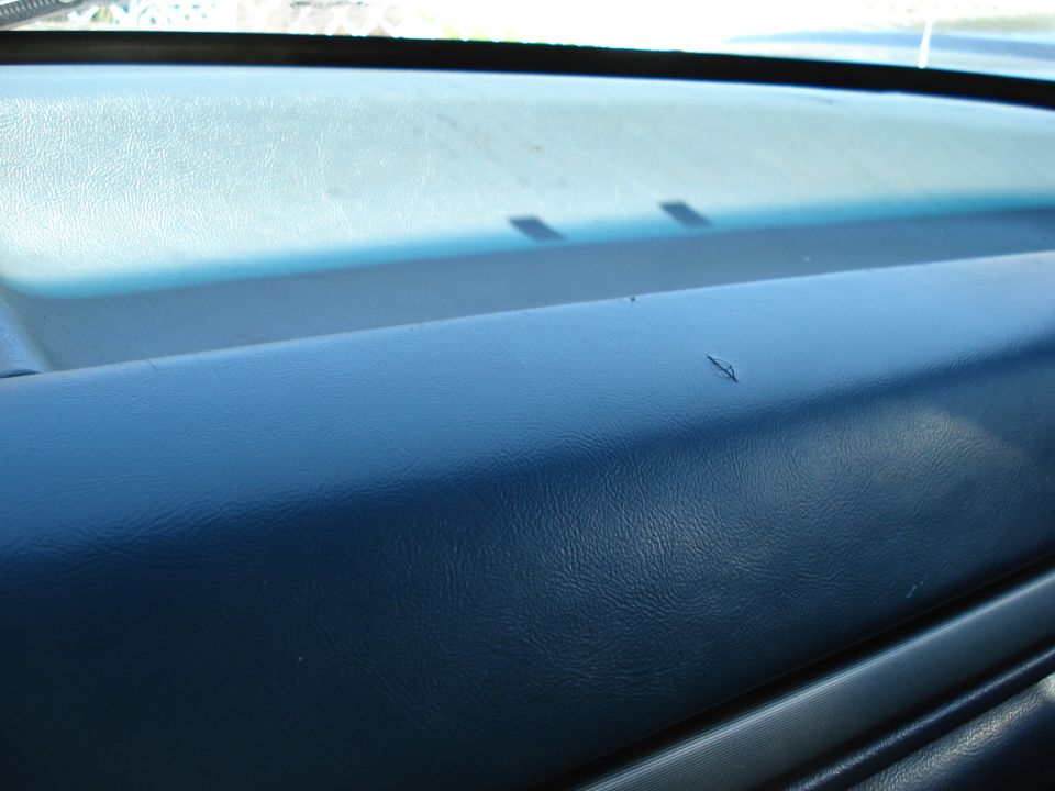 Dashboard surface with a small scratch. Watermark reads SUPERMOTORS