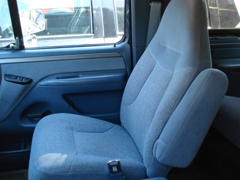 1994 Ford Bronco - Interior view of a 1994 Ford Bronco, focusing on the driver's side seat and door panel.