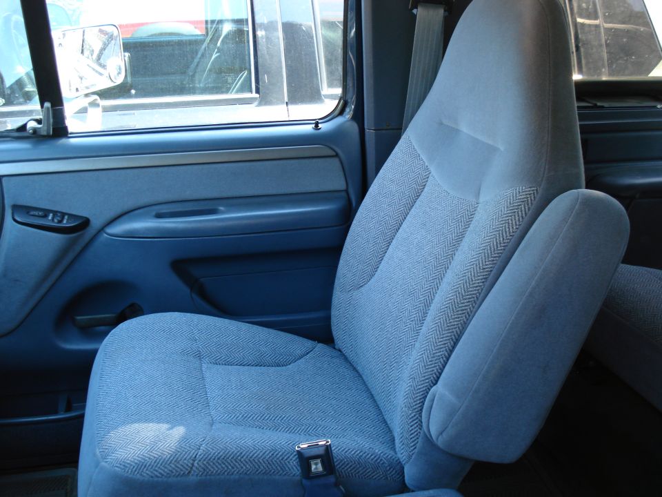 1994 Ford Bronco interior showing blue fabric front seats and door panel