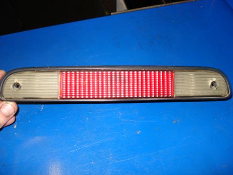 1994 Ford Bronco - A close-up view of a vehicle's third brake light assembly, showing its red and clear lens components.