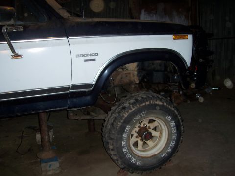 1983 Ford Bronco - The side profile of a 1983 Ford Bronco shows its distinctive two-tone paint scheme and the model name on the fender.