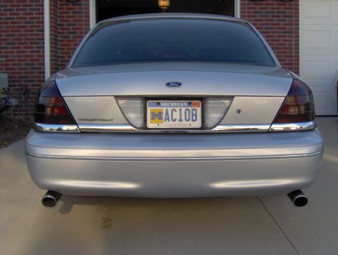 2002 Ford Crown Victoria - Rear view of a silver 2002 Ford Crown Victoria sedan with tinted taillights and a Michigan license plate.