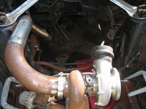 1969 Ford Mustang - Custom turbocharger and exhaust piping installation is visible in this underside view.