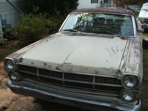 1966 Ford Ranchero - Front view of a weathered 1966 Ford Ranchero, showing its distinctive grille and headlights.