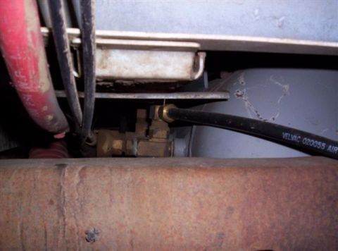 1995 Ford Bronco - Detail of an air brake system with hoses and a valve, exhibiting signs of rust and wear.