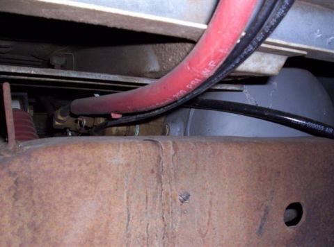 1995 Ford Bronco - Close-up view of a red hose marked '200 PSI W.P.' and other undercarriage components.